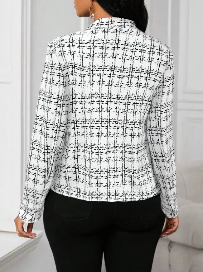 Person wearing a black and white checkered shirt against a neutral background